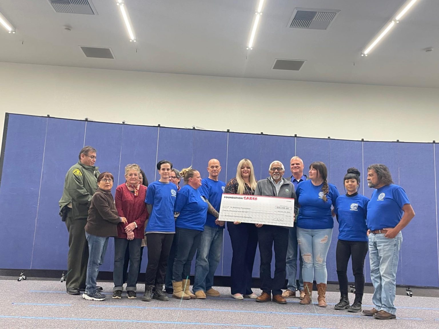 Roque and group from NorthEnd holding large check from BHE Foundation Cares