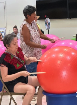 Older women drumming on exercise balls_ECO group